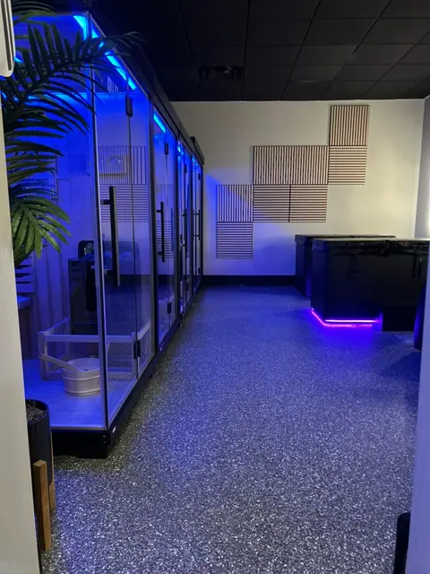 Blue-lit recovery room with private recovery booths