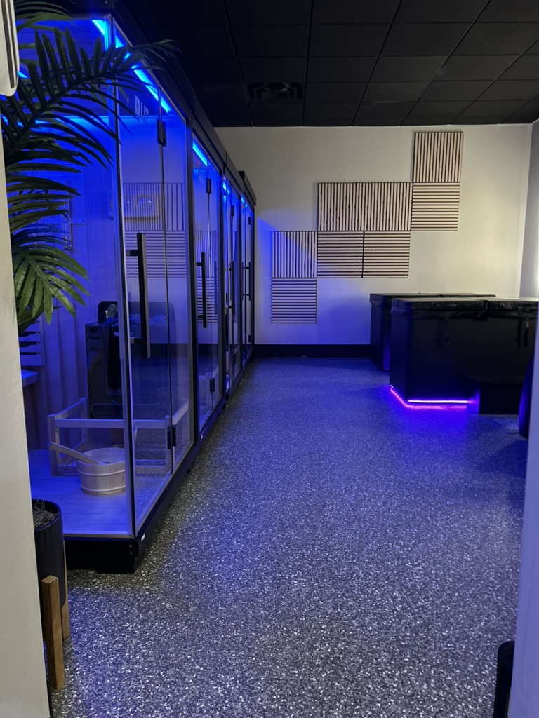 Blue-lit recovery room with private recovery booths